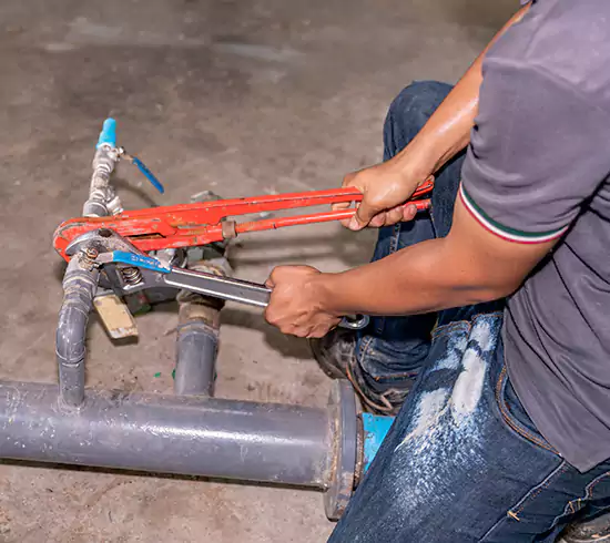 Licensed plumber repairing a copper pipe leak in a Indiana basement
